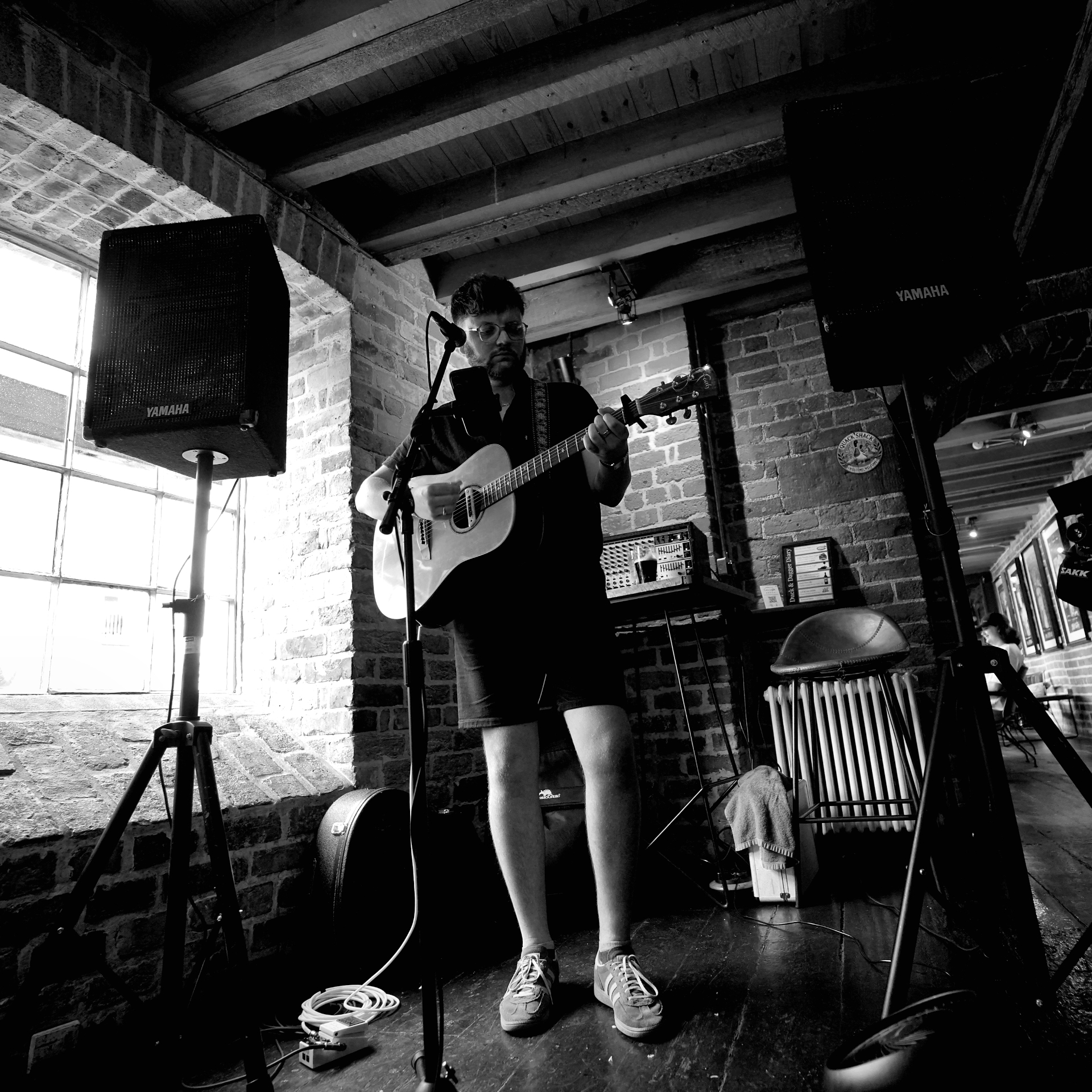 Acoustic set in a brick-walled Chester venue